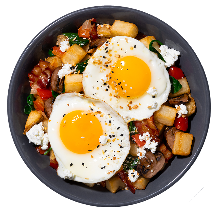 A hash bowl of crispy potatoes, eggs, spinach, bacon, mushrooms and cheese